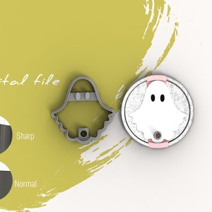 May include: A digital file for a ghost-shaped cookie cutter. The cutter is shown in gray and the finished cookie is shown in white with black eyes. The text "Digital file" is shown in the image.