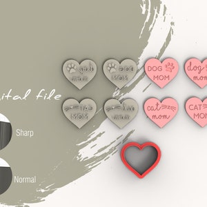 May include: A set of six heart-shaped cookie cutters with various pet-themed designs. The cutters are pink and grey and feature the text "Dog Mom", "Cat Mom", and "Paw Mom".