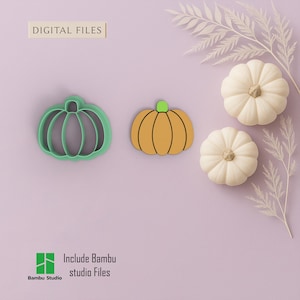 May include: An image featuring a green pumpkin-shaped cookie cutter and a pumpkin-shaped cutout with an orange body and green stem. Two white pumpkins and text that reads "DIGITAL FILES" and "Include Bambu studio Files" are also visible.