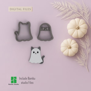 May include: A Halloween-themed image featuring three cookie cutters: a cat, a ghost, and a cat in a ghost costume. Two small white pumpkins and decorative foliage are also present. The text "DIGITAL FILES" and "Include Bambu studio Files" are visible.
