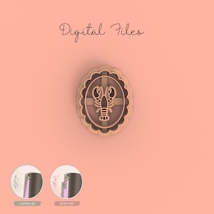 May include: A tan lobster-shaped cookie cutter with an oval, scalloped border. The lobster is centered within a cross-shaped design. The words "Digital Files" are written in cursive at the top. Two small circular images at the bottom show the lip of a container.