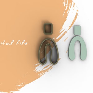 Peut inclure: Deux emportes-pièces, l'un brun et l'autre vert, en forme de lettre "n" avec un petit carré sur le dessus. Le texte "Fichier numérique" est visible en arrière-plan.