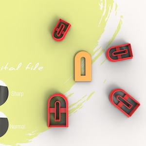 Könnte beinhalten: Fünf Ausstecher in verschiedenen Formen und Farben. Die Ausstecher sind in Form von Bögen mit einem kleinen Rechteck in der Mitte. Die Ausstecher sind rot, orange und schwarz. Der Text "Digitale Datei" ist im Hintergrund sichtbar.