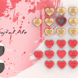 May include: A set of 12 heart-shaped cookie cutters with various messages, including "You Wish", "No Thanks", "Get Lost", "Hate You", and "Just No". The cutters are red and gold, and are arranged in a grid pattern on a pink and white background.