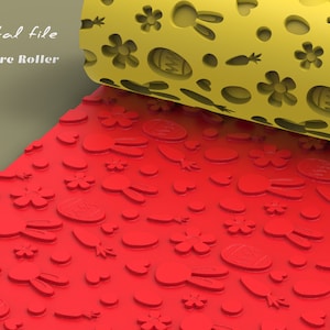 May include: A yellow texture roller with a repeating pattern of Easter eggs, bunnies, flowers, and carrots. The roller is rolling over a red surface that has the same pattern embossed into it.