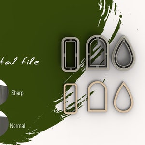 May include: A set of three cookie cutters in the shapes of a rectangle, arch, and teardrop. The cutters are made of silver metal and have a sharp, defined edge. The cutters are shown on a white surface.