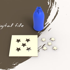 May include: A blue star-shaped cookie cutter with five points and a white square cookie cutter with five star-shaped cutouts. There are six white star-shaped cookies on a white surface.