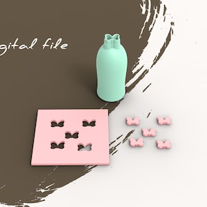 May include: A set of six pink butterfly-shaped silicone molds and a light green silicone mold in the shape of a bottle. The molds are on a white surface. Digital file.