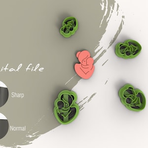 May include: A set of five cookie cutters, including a mother and child design, and four floral designs. The cutters are green and the mother and child design is pink.