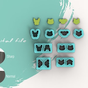 May include: A set of 12 cookie cutters in various animal shapes, including butterflies, frogs, and foxes. The cutters are made of blue plastic and are arranged in rows on a white surface. The text "Digital file" is visible in the image.