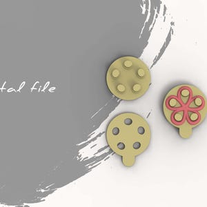 May include: Three digital files for 3D printing. Two are round with six holes each, one is round with a pink flower design.