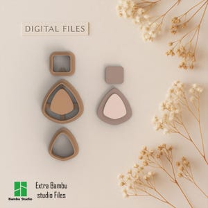 May include: A collection of earring-shaped digital files in various geometric forms, including squares and triangles. The files are in shades of beige and taupe, with the text "DIGITAL FILES" and "Extra Bambu studio Files" visible.