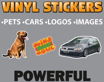 May include: Vinyl stickers for pets, cars, logos, and images. The image shows a brown dog, a car, and a sticker with the text "Mind Body Soul". The text "Powerful Printing" is printed in black with colorful paint splatters.
