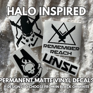 Könnte beinhalten: Eine Sammlung schwarzer Vinyl-Aufkleber mit Halo-inspirierten Grafiken, darunter ein Totenkopf-Emblem, ein dreieckiges Logo mit dem Text REMEMBER REACH und das Akronym UNSC. Der Text HALO INSPIRED und PERMANENT MATTE VINYL DECALS ist sichtbar.