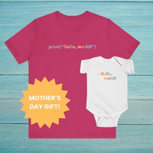 May include: A pink t-shirt with the text "print("Hello, world!")" and a white baby onesie with the text "> Hello, world!" in rainbow colors. A yellow starburst sticker says "MOTHER'S DAY GIFT!"