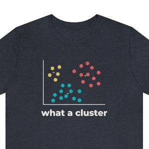 May include: Dark navy blue t-shirt featuring a data visualization graphic with yellow, red, and blue clusters. The text "what a cluster" is printed below the graphic in white. A casual, comfortable tee.