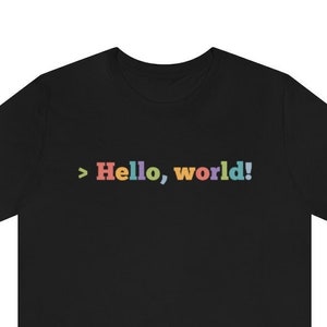 May include: Black t-shirt with the text "> Hello, world!" in rainbow colors.
