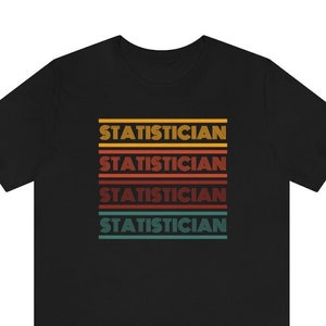 May include: Black t-shirt with the word "STATISTICIAN" repeated four times in a retro rainbow design.