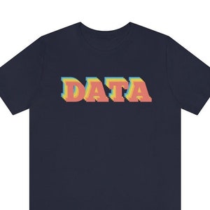 May include: A navy blue t-shirt with the word "DATA" printed in a retro, multi-colored, pixelated font.