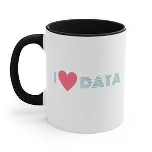 May include: White ceramic mug with a black handle and interior. The mug features the text "I ♥ DATA" in pink and teal. The mug is designed for hot beverages.