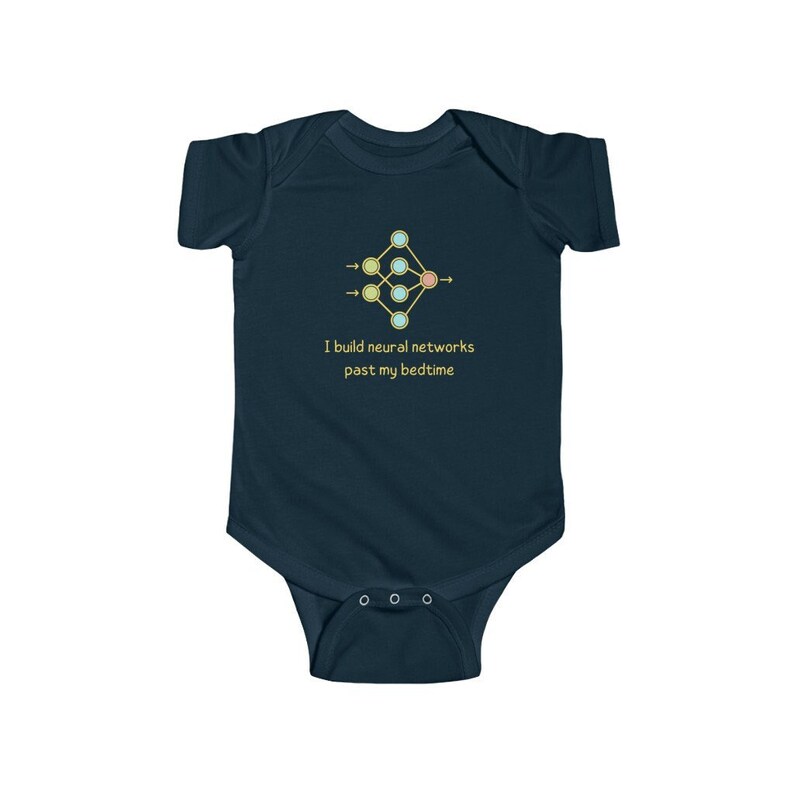 May include: A dark blue baby growsuit with a yellow, green, and pink neural network diagram and the text "I build neural networks past my bedtime".