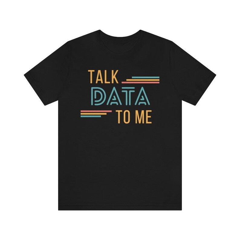 May include: Black t-shirt with the text "TALK DATA TO ME" in a retro font with colorful stripes.