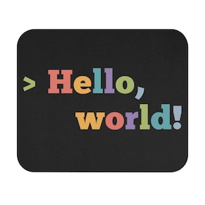May include: A black mouse pad with the text "> Hello, world!" in colorful letters. The letters are in different colors, including red, orange, yellow, green, blue, and purple.