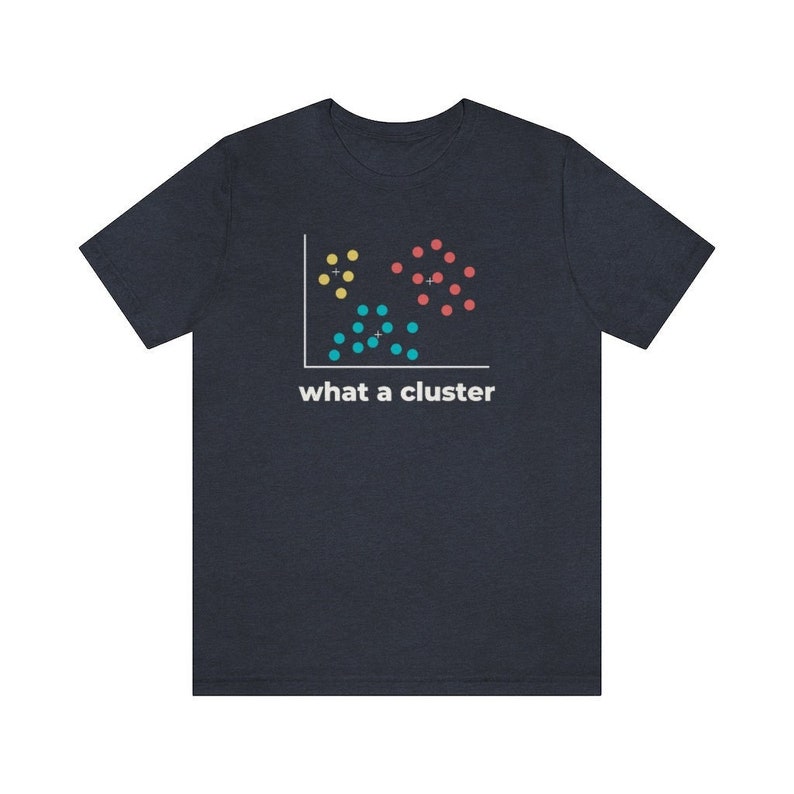 May include: Dark navy blue t-shirt featuring a data visualization graphic with yellow, red, and blue clusters. The text "what a cluster" is printed below the graphic in white. A casual, comfortable tee.