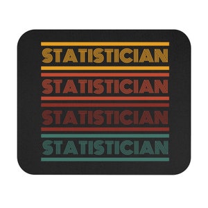 May include: A black mouse pad with the word "STATISTICIAN" repeated four times in a retro style font. Each word is in a different color: yellow, red, orange, and teal.