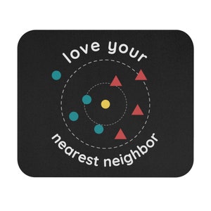 May include: Black rectangular mousepad with the words "love your nearest neighbor" in white. The design includes teal circles, red triangles, and a yellow circle, arranged around a dotted circle.