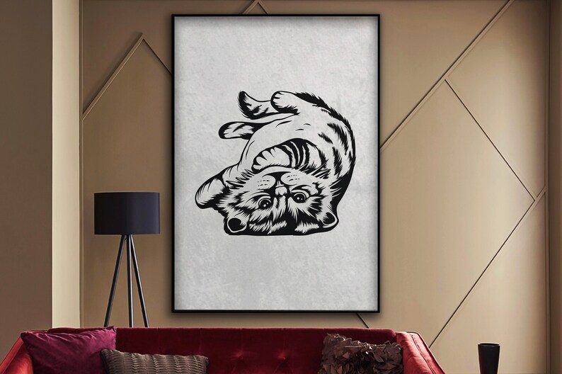 May include: Black and white illustration of a cat upside down with its paws in the air and a playful expression on its face.