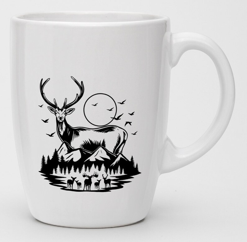 May include: White ceramic mug with a black silhouette of a deer standing on a mountain with a full moon in the background. There are smaller deer in the foreground.
