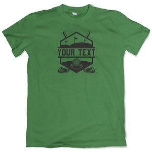 May include: Green t-shirt with a black golf-themed graphic. The graphic features a golf ball, two crossed golf clubs, and the text "YOUR TEXT".