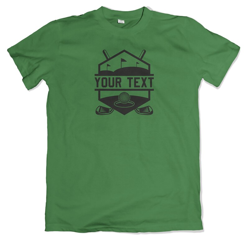 May include: Green t-shirt with a black golf-themed graphic. The graphic features a golf ball, two crossed golf clubs, and the text "YOUR TEXT".