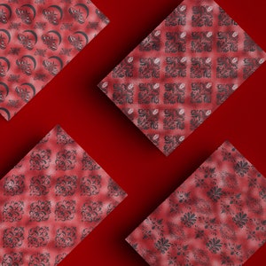 May include: Four red squares with different black and white patterned designs. The patterns are intricate and include floral and geometric motifs.