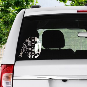 May include: A white car with a black and white football player decal on the back window. The decal features a football player in a kicking position with the text "YOUR TEXT" and "#10" on the football.