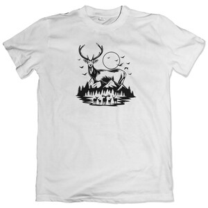 May include: A white t-shirt with a black silhouette of a deer standing in a forest with a full moon in the background.