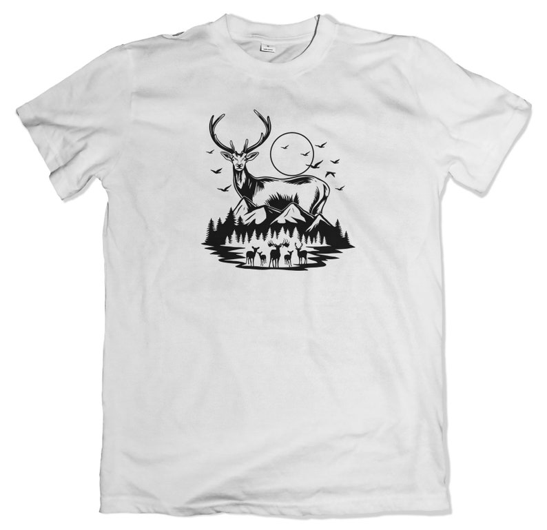 May include: A white t-shirt with a black silhouette of a deer standing in a forest with a full moon in the background.