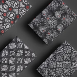 May include: Four different black and white patterned wrapping paper sheets with a Halloween theme. The patterns include skulls, roses, spiderwebs, and a repeating geometric design.