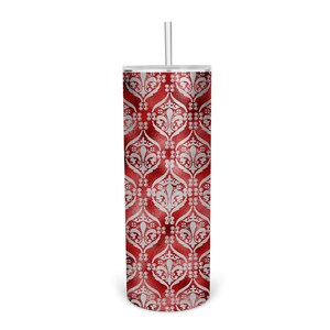 May include: A red and silver stainless steel tumbler with a damask pattern. The tumbler has a lid and a straw.