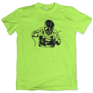 May include: A lime green t-shirt with a black and white illustration of a welder wearing a welding mask and welding.