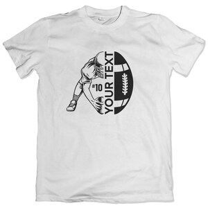 May include: White t-shirt with a black and white graphic of a football player running with the ball and a football. The text "YOUR TEXT" is on the football.