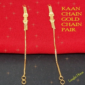 Puede incluir: Un par de cadenas de oro con un diseño decorativo. Las cadenas miden 14 mm de largo y se muestran sobre un fondo de tela roja. El texto "KAAN CHAIN GOLD CHAIN PAIR" es visible en la imagen.