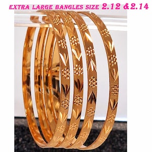 May include: Set of five gold-tone bangles with a textured design. The bangles are 5.4 cm and 5.4 cm in diameter.
