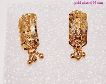 May include: A pair of gold-plated stud earrings with a textured design and three small dangling balls. The earrings are 8 mm by 14 mm. The text "stud earrings gold plated 14 mm" and "kapa-jewellery collection S17 8X14MM" is visible in the image.