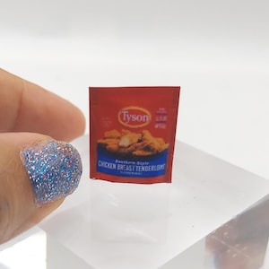 May include: A miniature red and white packet of Tyson Southern Style Chicken Breast Tenderloins. The packet shows a picture of breaded chicken tenders.