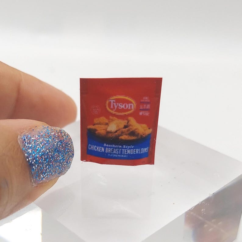 May include: A miniature red and white packet of Tyson Southern Style Chicken Breast Tenderloins. The packet shows a picture of breaded chicken tenders.