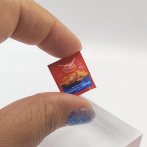 May include: A miniature red and blue Tyson brand package of Southern Style Chicken Breast Tenders.