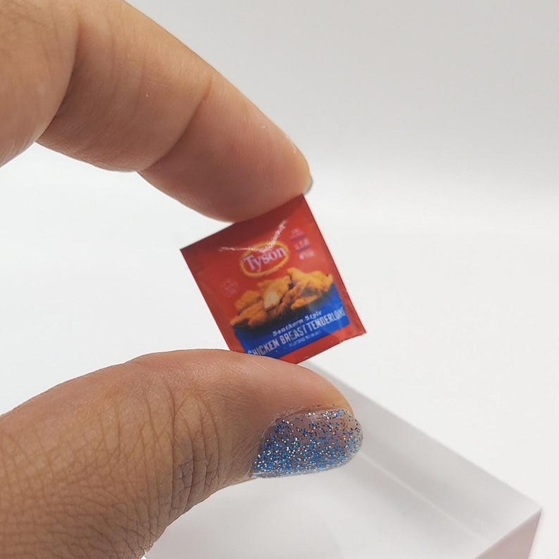 May include: A miniature red and blue Tyson brand package of Southern Style Chicken Breast Tenders.