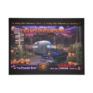 May include: A vintage, blue car parked in front of a camper trailer with a sign that reads "Crumpkinspumpkins.com". The scene is set in a field with pumpkins and corn stalks. The text "Eeek! "The Pumpkin Song" - Now has 2,000,000+ views on YouTube!" is visible in the image.